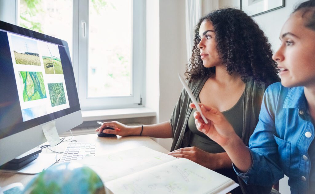 Young woman doing research together at desk