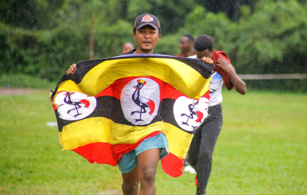 Photo by Timothy Nkwasibwe: https://www.pexels.com/photo/man-running-holding-a-flag-8450907/