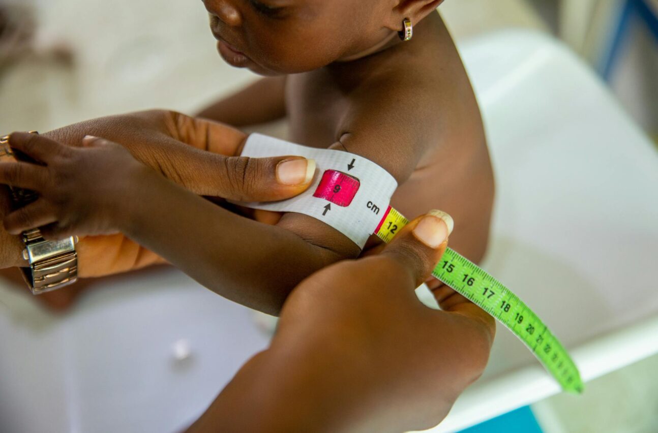 Young African child being examined by healthcare provider