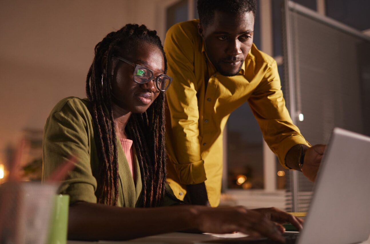 man and woman working on laptop