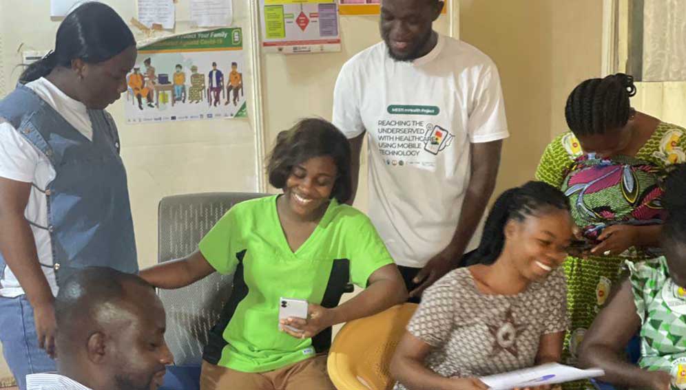 Rose-Mary Gyening interacting with rural health workers on how to use the app. Researchers developed the mobile app to connect Ghana's rural communities to healthcare services. Copyright: Theodore A. Korku Mawutor