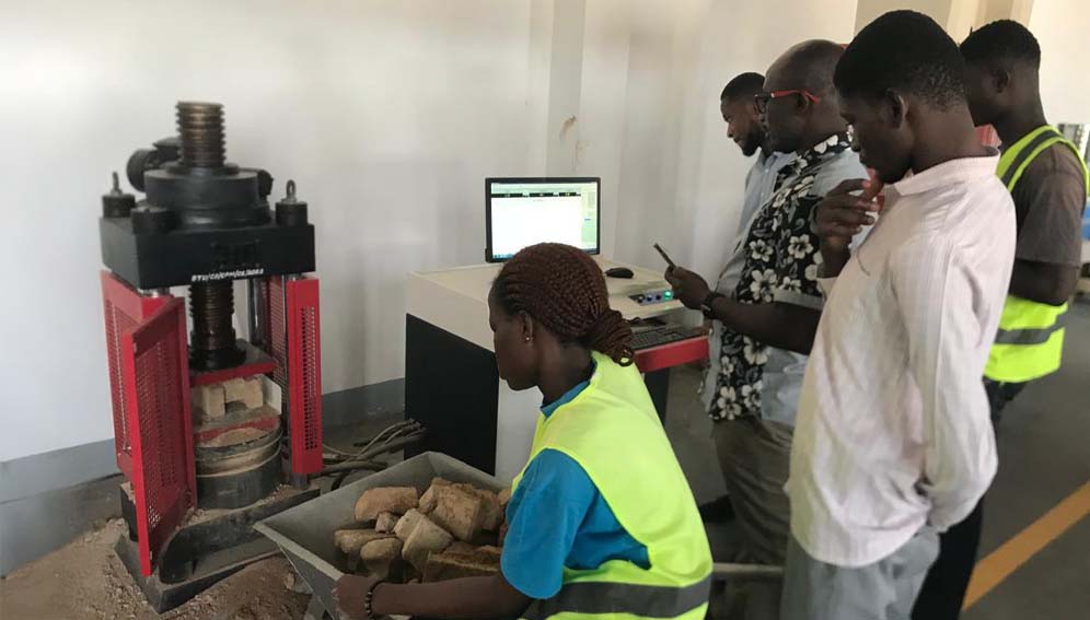 Researchers observing the blocking making process in the machine. Credit: Prof Callistus Tengan