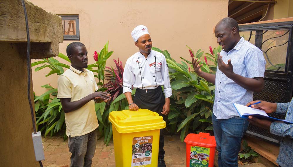 Lead researcher Geoffery Ssepuuya interracting with one of the raw food suppliers which he turns into cricket food