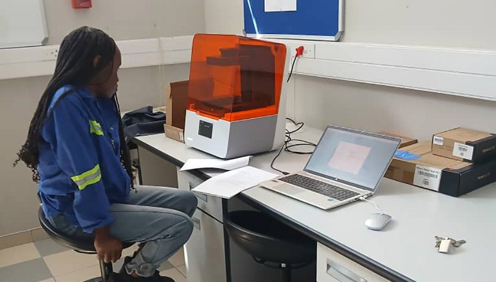 Student observing the 3D printing of segmented tumors
